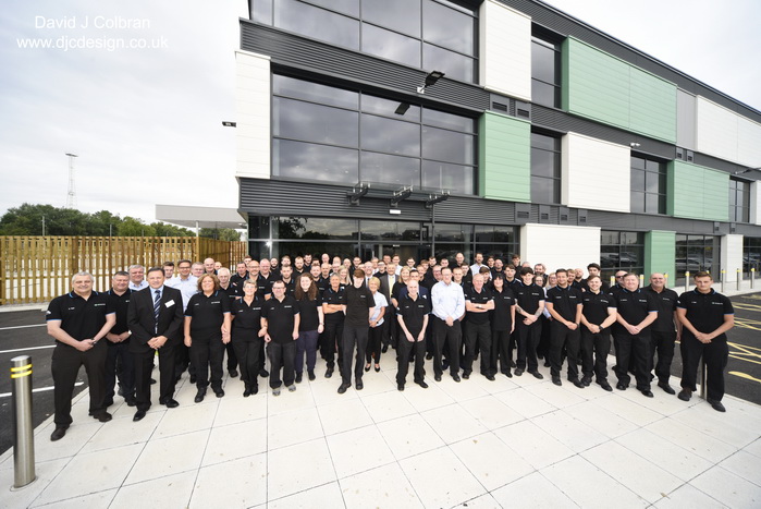 Large group photography outside a new factory