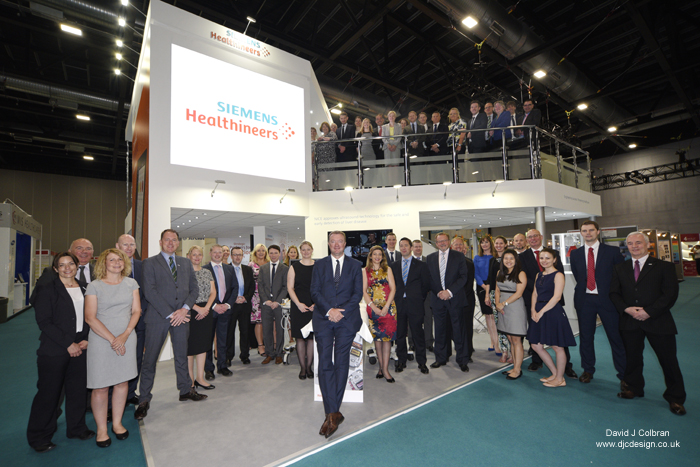 Large staff group photograph at exhibition stand Liverpool