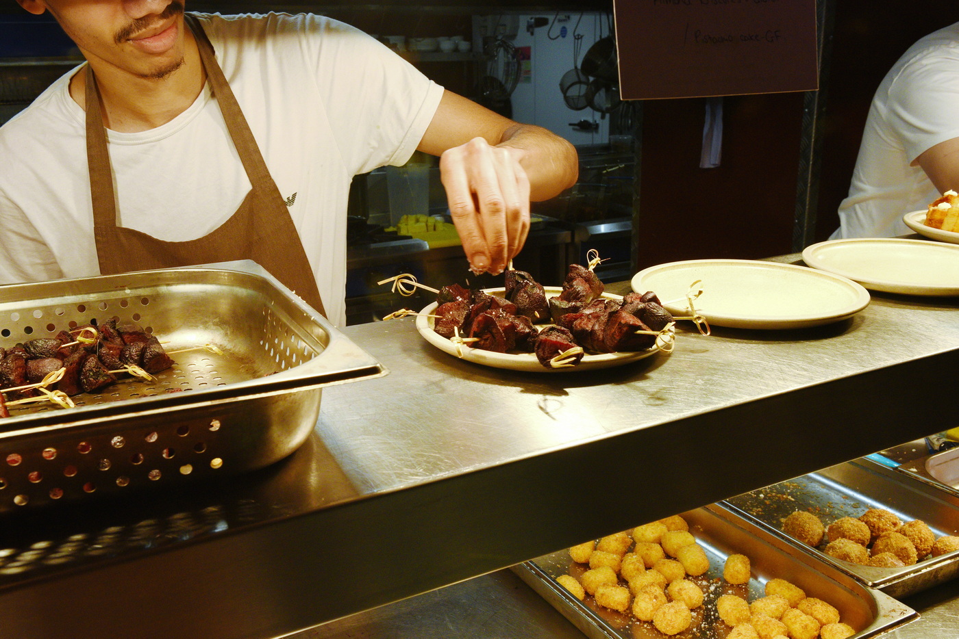 Chefs providing the final touches to guest food at business event