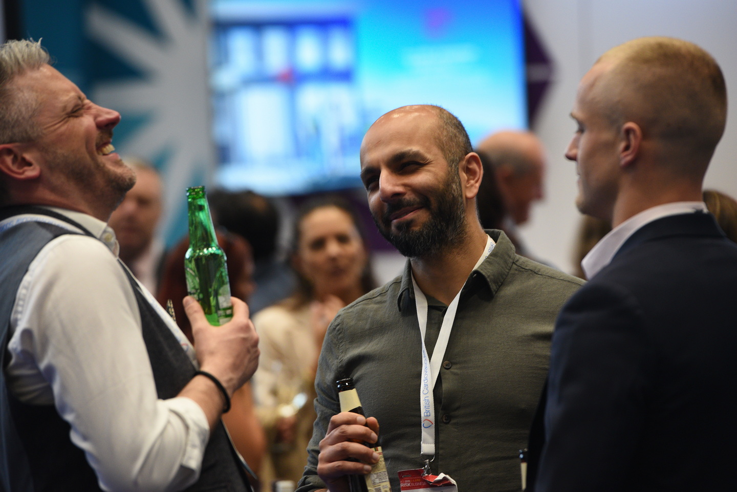 Delegates laughing and enjoying themselves at an exhibition drinks reception