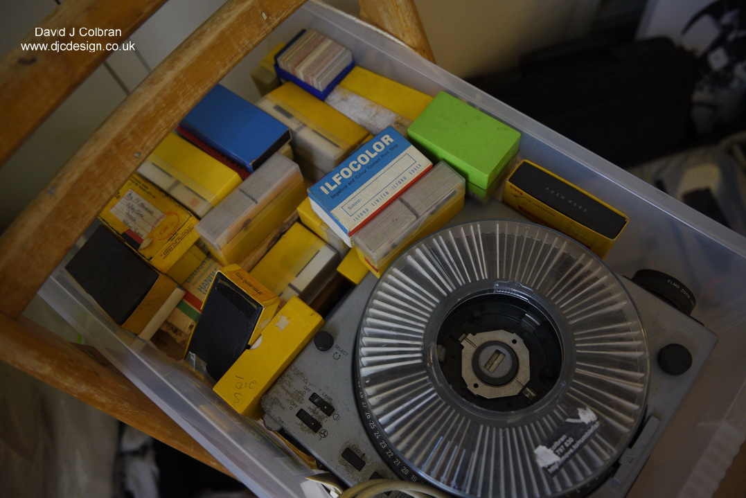 Collection of slides and a projector in a box