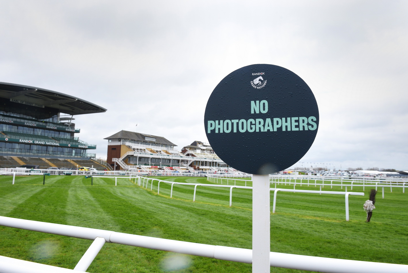 Editorial photo for The Racing Post - an empty course on a rainy day with the sign No Photographers